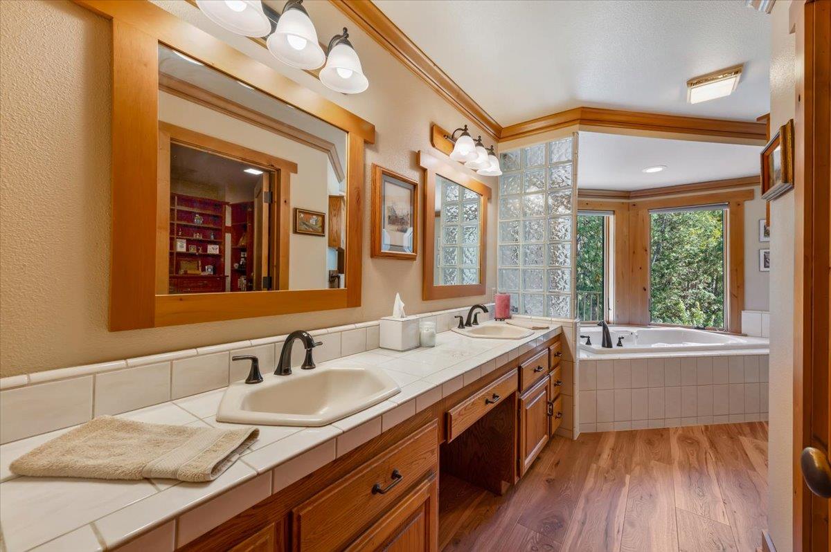 11790 Lowhills Road Nevada City, CA 95959 - Photo 26 of 68 a bathroom with a granite countertop sink mirror vanity and bathtub
