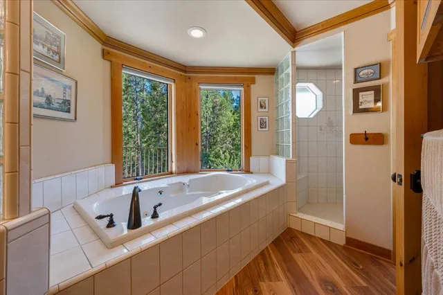 a living room with furniture flat screen tv and a large window