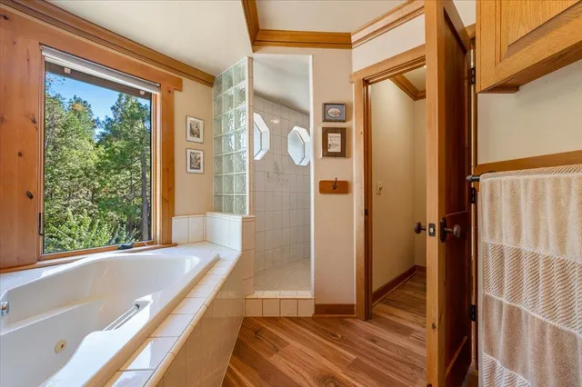 a living room with fireplace furniture and a large window