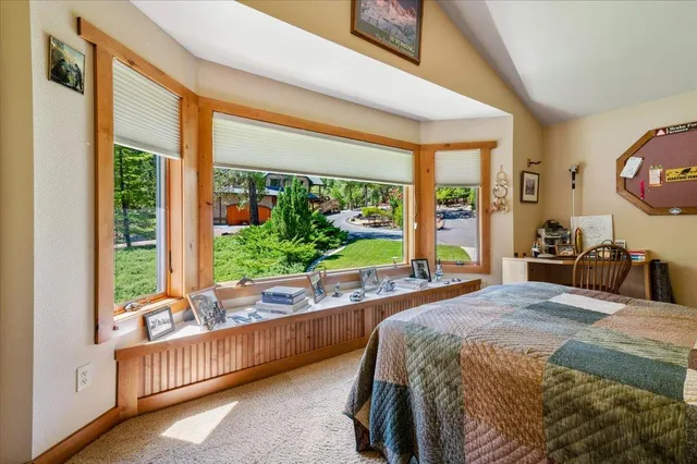 a bedroom with a large bed and a large window