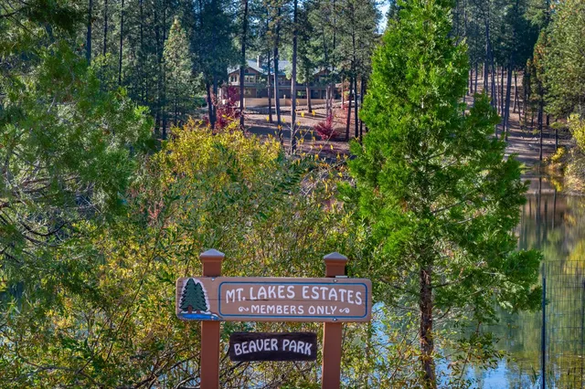 an aerial view of a house with swimming pool garden and patio