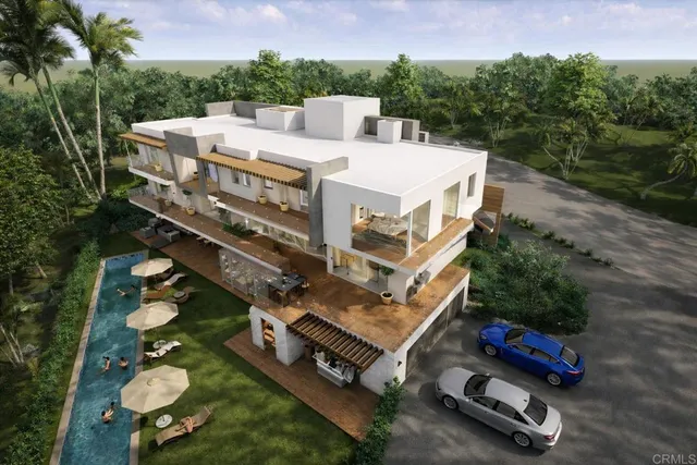 an aerial view of a house with a garden and trees