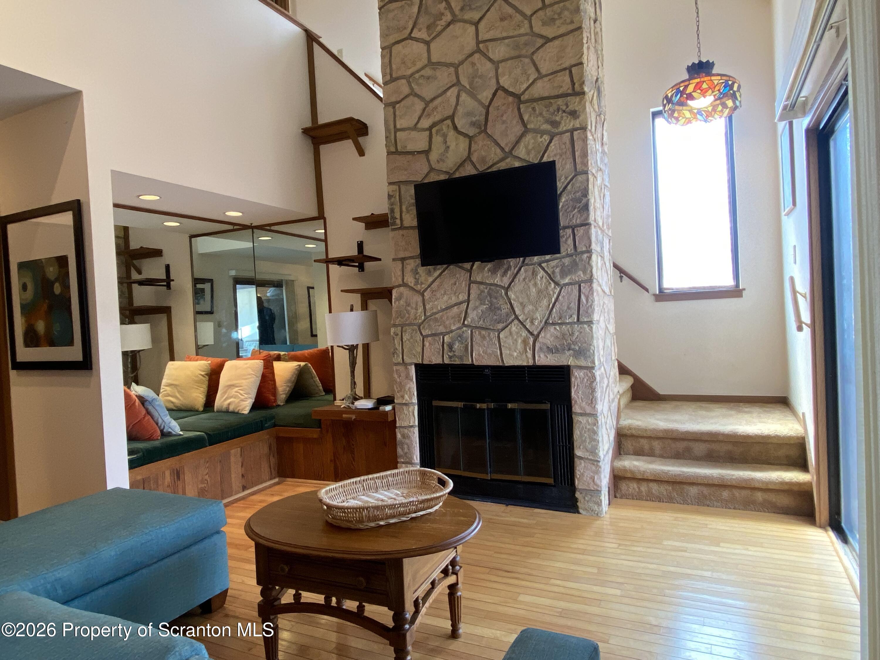 211 Falls Circle Bushkill, PA 18324 - Photo 26 of 28 a living room with furniture a fireplace and a flat screen tv