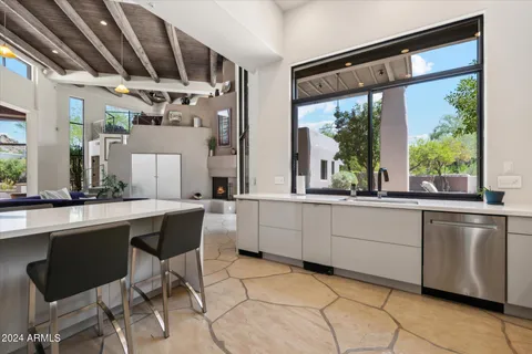 a large white kitchen with a large window
