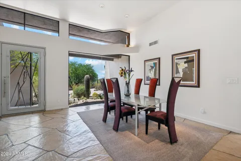 a view of a dining room with furniture and a potted plant