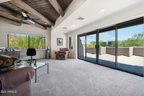 a living room with furniture and a floor to ceiling window