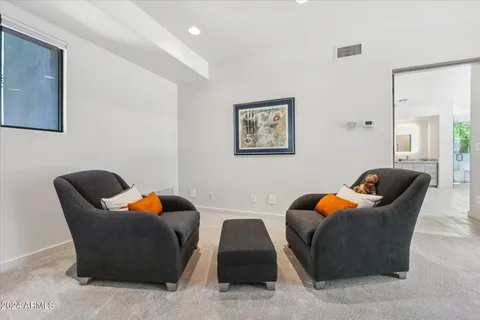 a living room with furniture and a lamp