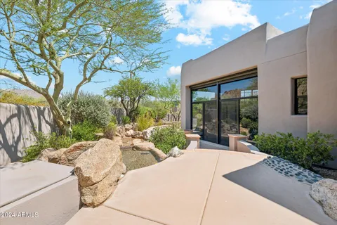 a view of a backyard with sitting area and garden