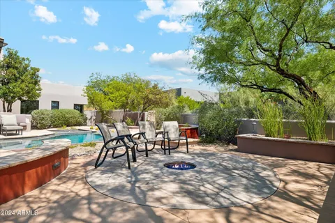 a view of a backyard with sitting area