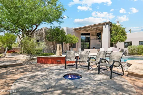 a view of a patio with couches and table and chairs and potted plants