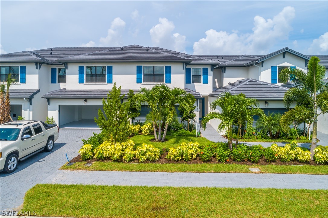 7341 Rockefeller Drive Naples, FL 34119 - Photo 1 of 34 a front view of a house with a yard