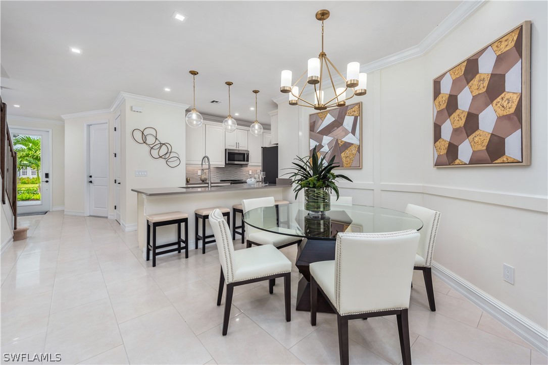 7341 Rockefeller Drive Naples, FL 34119 - Photo 12 of 34 a view of a dining room with furniture and chandelier