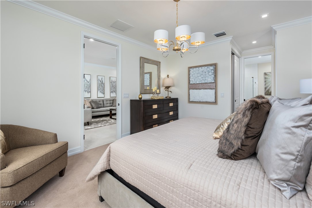 7341 Rockefeller Drive Naples, FL 34119 - Photo 17 of 34 a spacious bedroom with a bed a chandelier and dresser