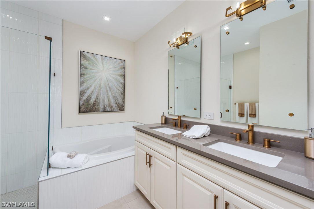 7341 Rockefeller Drive Naples, FL 34119 - Photo 18 of 34 a bathroom with a granite countertop sink mirror and a