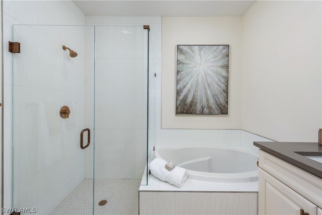 7341 Rockefeller Drive Naples, FL 34119 - Photo 19 of 34 a bathroom with a tub and a shower