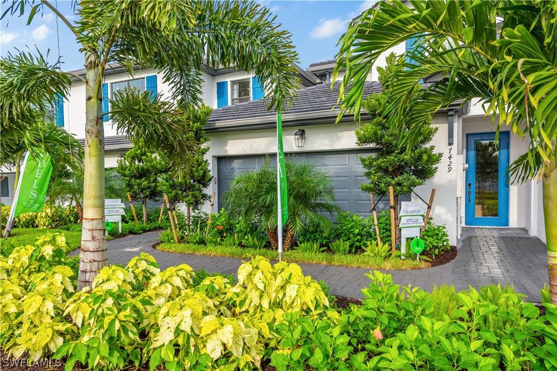 7341 Rockefeller Drive Naples, FL 34119 - Photo 2 of 34 a view of a garden with a fountain