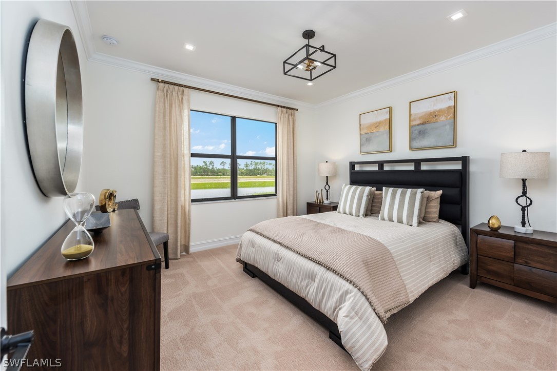 7341 Rockefeller Drive Naples, FL 34119 - Photo 23 of 34 a bedroom with a bed and a chandelier