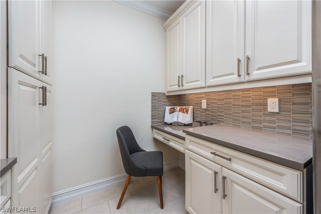 7341 Rockefeller Drive Naples, FL 34119 - Photo 25 of 34 a kitchen with a sink cabinets and chair