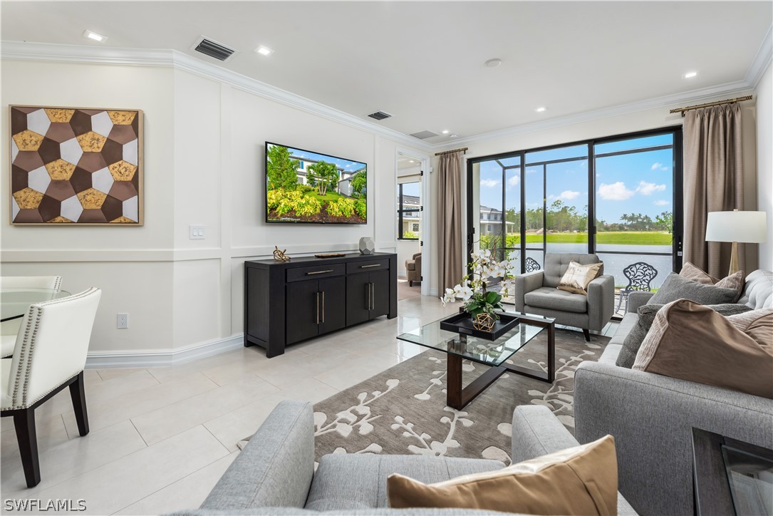 7341 Rockefeller Drive Naples, FL 34119 - Photo 26 of 34 a living room with furniture and a flat screen tv