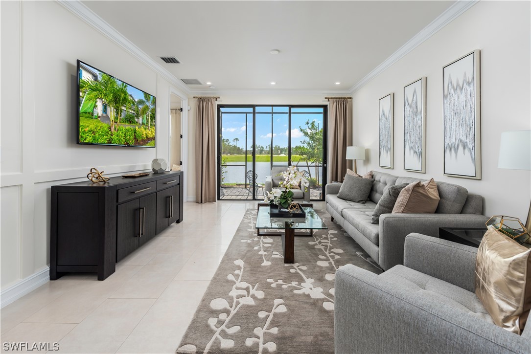 7341 Rockefeller Drive Naples, FL 34119 - Photo 27 of 34 a living room with furniture and a flat screen tv