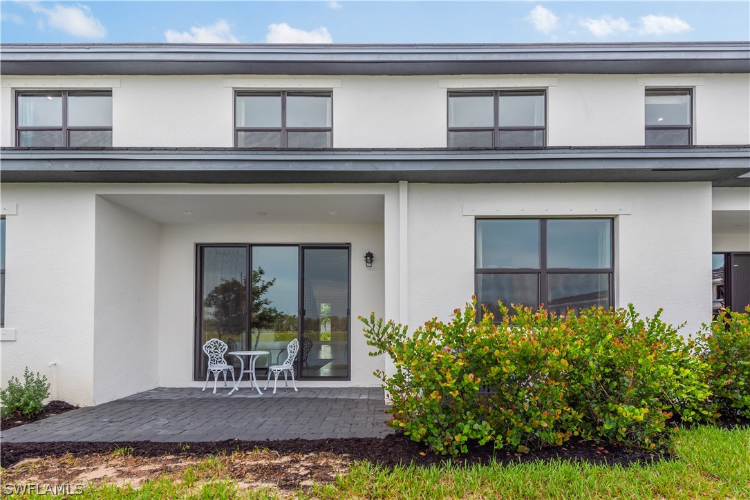 7341 Rockefeller Drive Naples, FL 34119 - Photo 10 of 34 a view of a house with a small yard and a large window