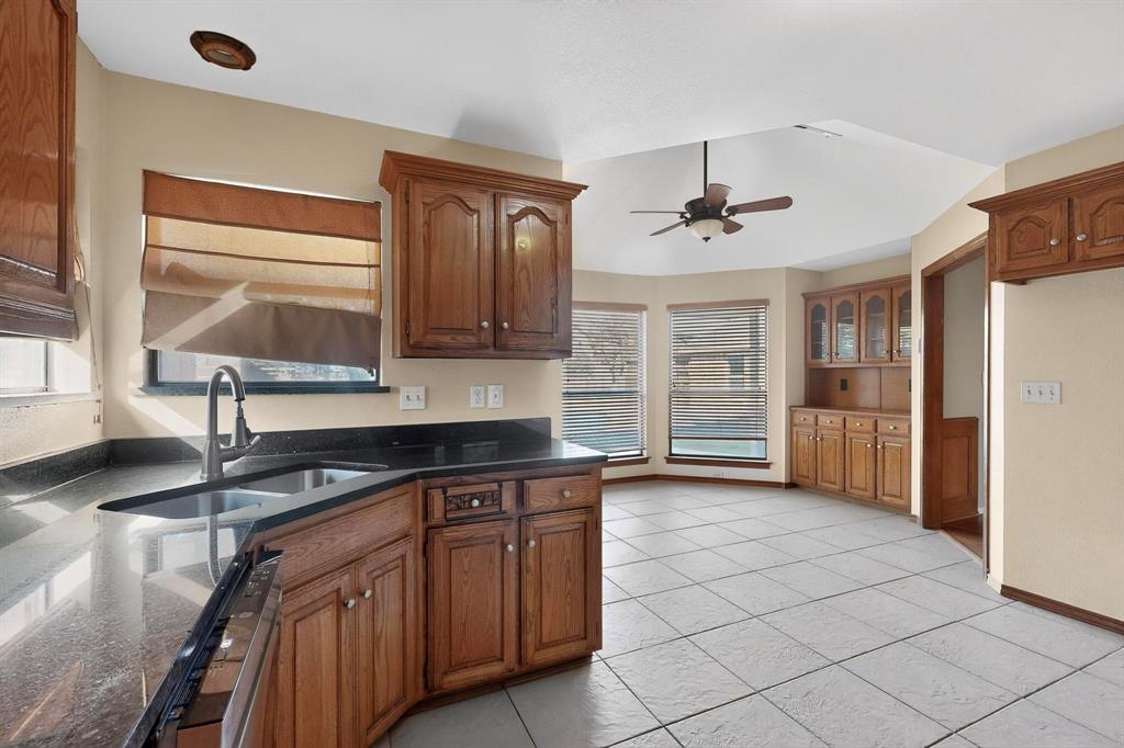 1121 Reedsport Place DeSoto, TX 75115 - Photo 13 of 40 a kitchen with stainless steel appliances granite countertop a sink and a refrigerator