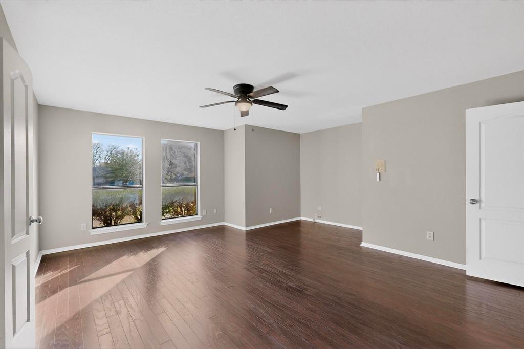 1121 Reedsport Place DeSoto, TX 75115 - Photo 16 of 40 an empty room with wooden floor and windows