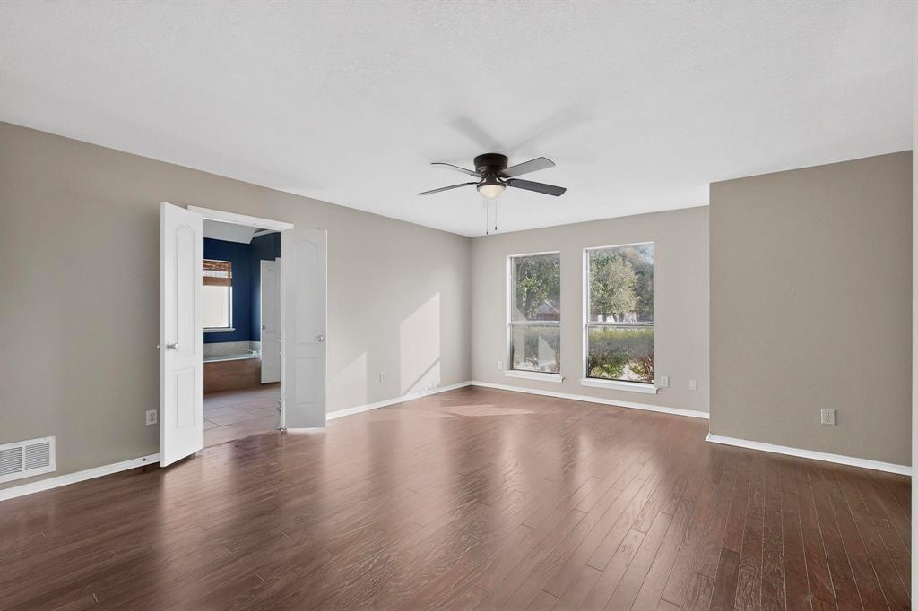 1121 Reedsport Place DeSoto, TX 75115 - Photo 17 of 40 a view of an empty room with a window and wooden floor