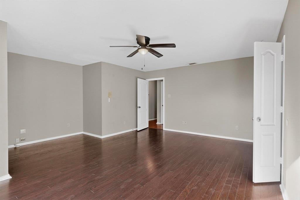 1121 Reedsport Place DeSoto, TX 75115 - Photo 18 of 40 an empty room with wooden floor and windows