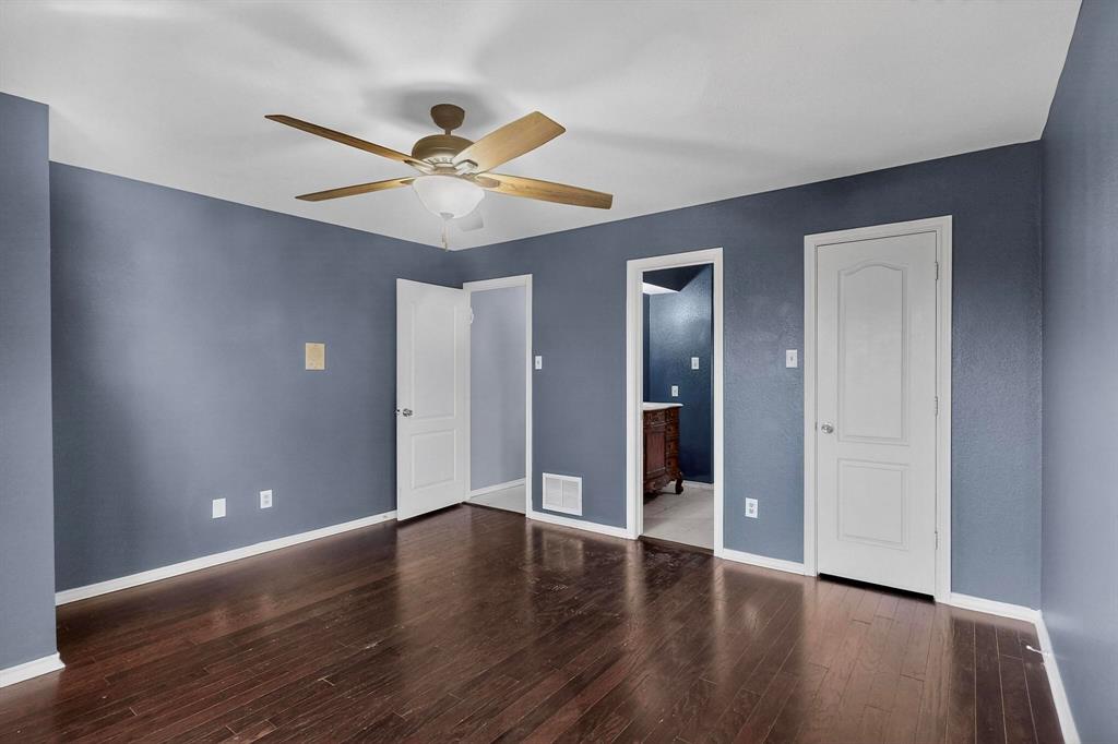 1121 Reedsport Place DeSoto, TX 75115 - Photo 24 of 40 an empty room with wooden floor a ceiling fan and a window