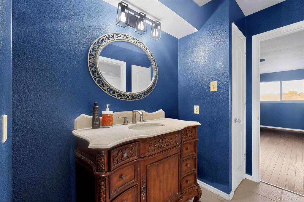 1121 Reedsport Place DeSoto, TX 75115 - Photo 27 of 40 a bathroom with a sink and a mirror