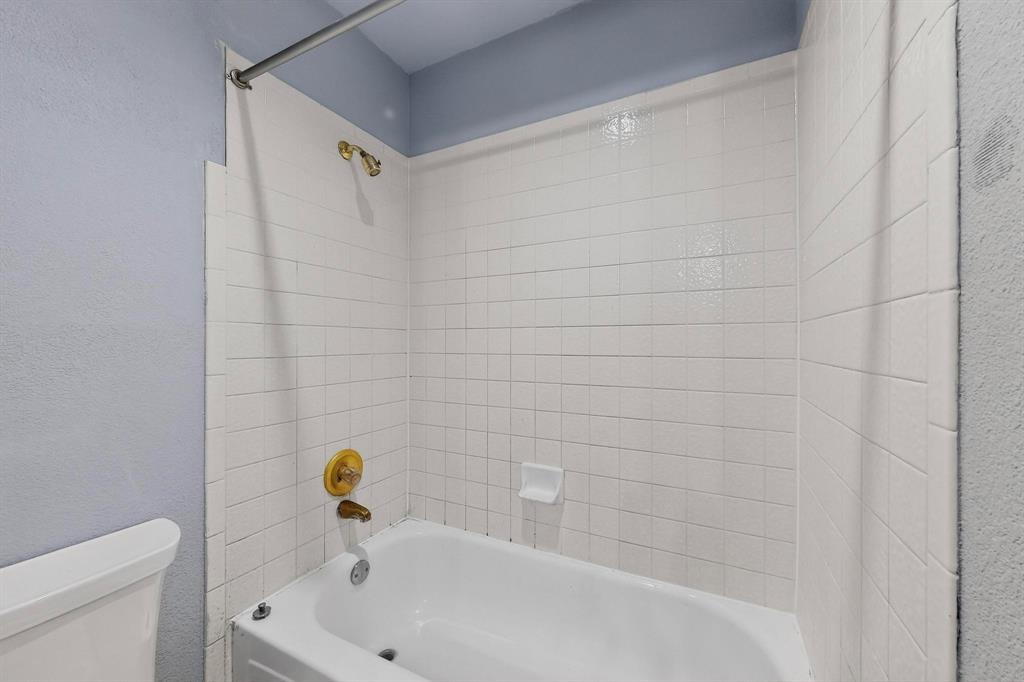 1121 Reedsport Place DeSoto, TX 75115 - Photo 28 of 40 a bathroom with a white bath tub and a shower