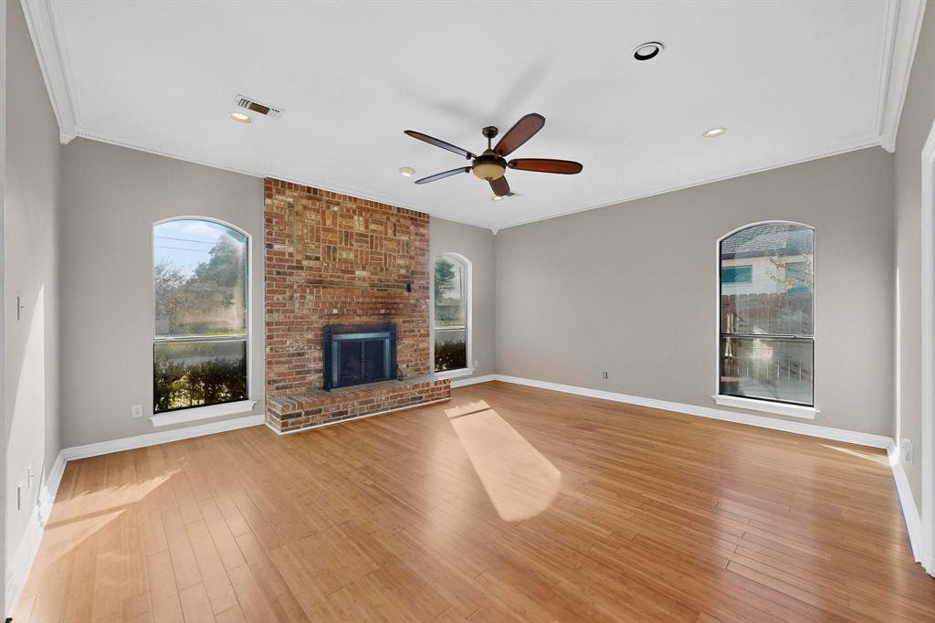 1121 Reedsport Place DeSoto, TX 75115 - Photo 6 of 40 a view of an empty room with a fireplace and a window