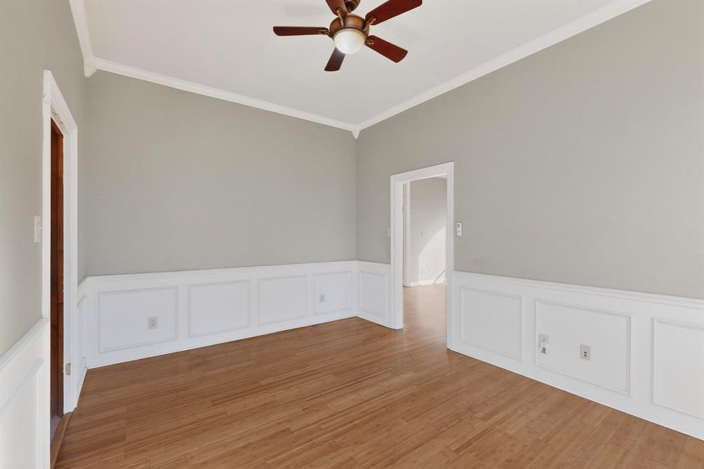 1121 Reedsport Place DeSoto, TX 75115 - Photo 8 of 40 an empty room with wooden floor ceiling fan and windows