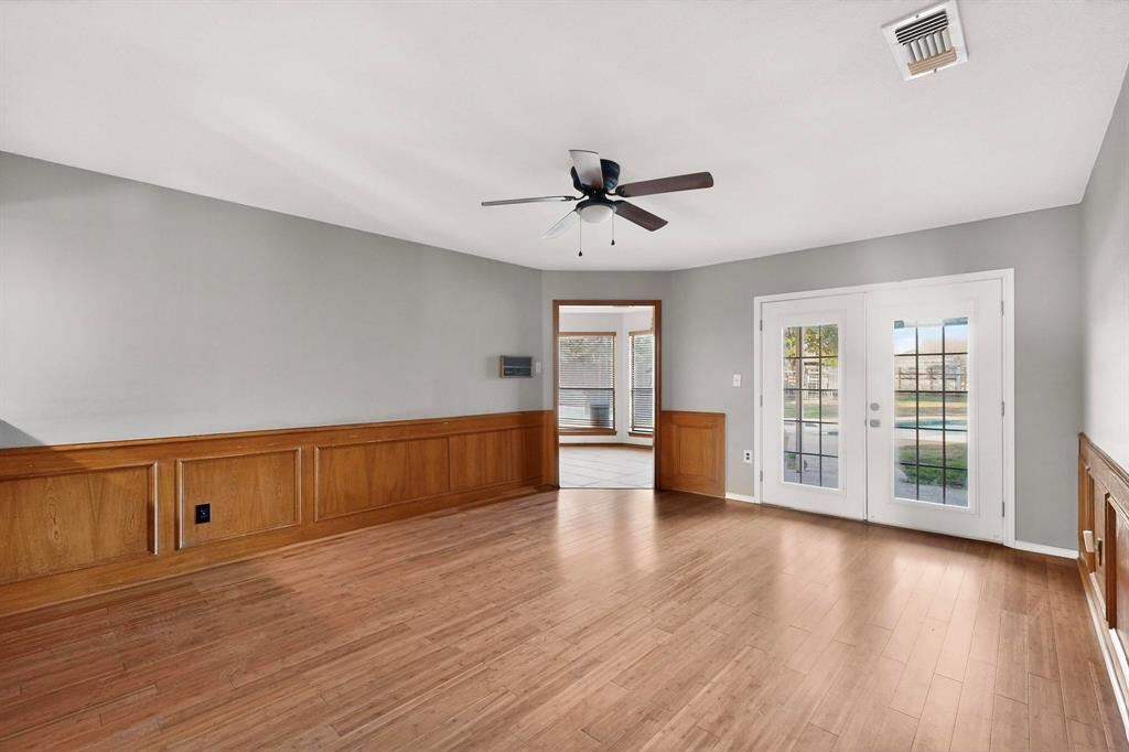 1121 Reedsport Place DeSoto, TX 75115 - Photo 9 of 40 a view of an empty room with wooden floor and a window
