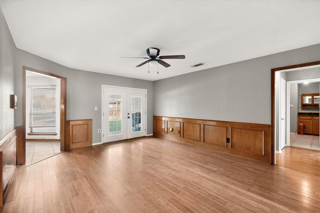 1121 Reedsport Place DeSoto, TX 75115 - Photo 10 of 40 a view of an empty room with wooden floor and a window