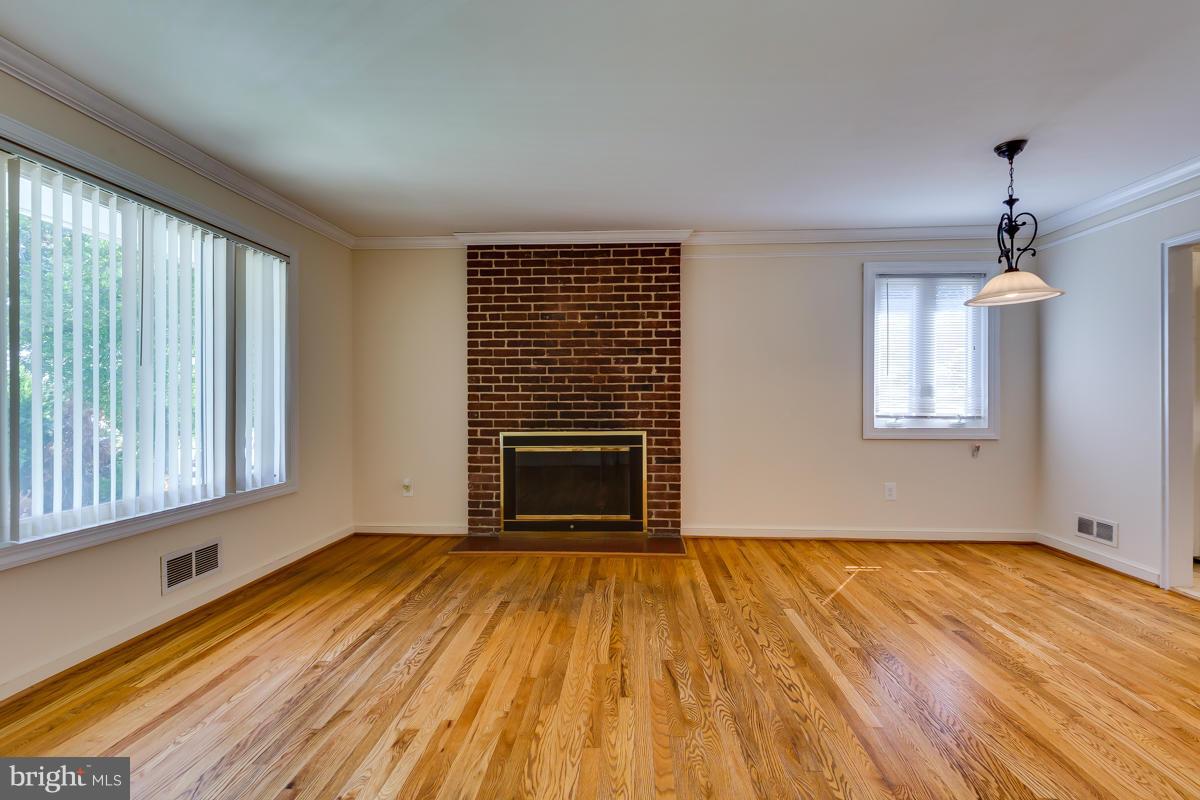 407 Royalton Road Silver Spring, MD 20901 - Photo 2 of 30 a view of empty room with wooden floor and fan