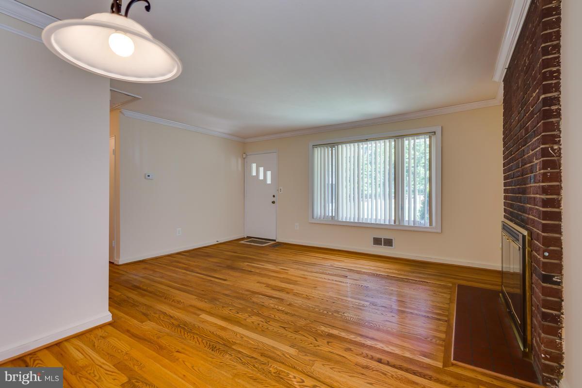 407 Royalton Road Silver Spring, MD 20901 - Photo 11 of 30 a view of an empty room with wooden floor and a window