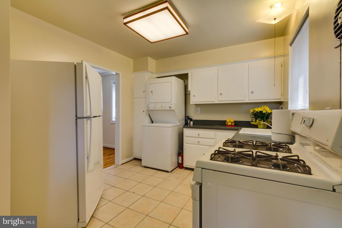 407 Royalton Road Silver Spring, MD 20901 - Photo 15 of 30 a kitchen with a refrigerator and a stove top oven