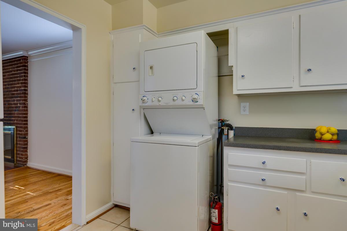 407 Royalton Road Silver Spring, MD 20901 - Photo 17 of 30 a utility room with cabinets washer and dryer