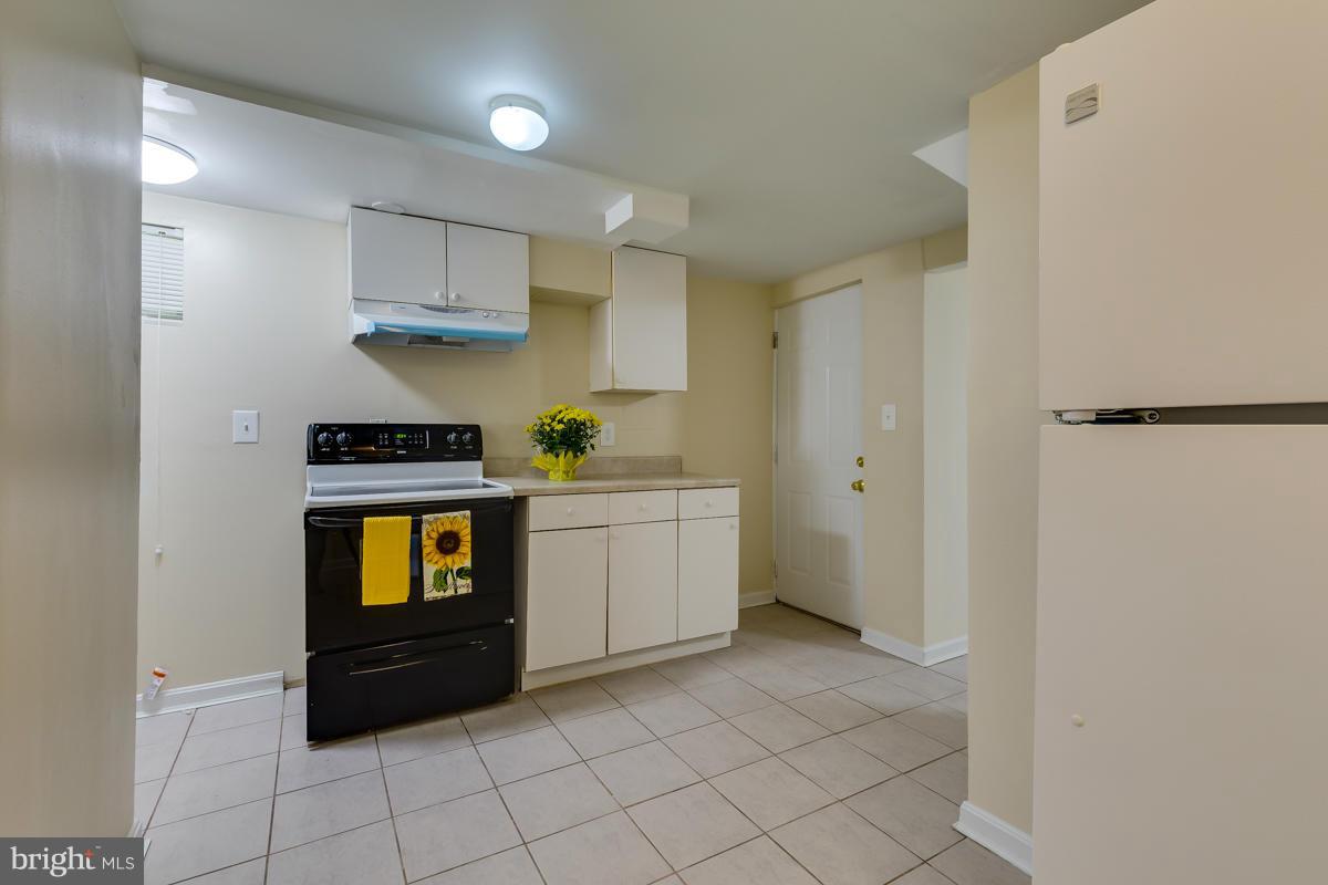 407 Royalton Road Silver Spring, MD 20901 - Photo 19 of 30 a kitchen with stainless steel appliances a refrigerator and a stove top oven