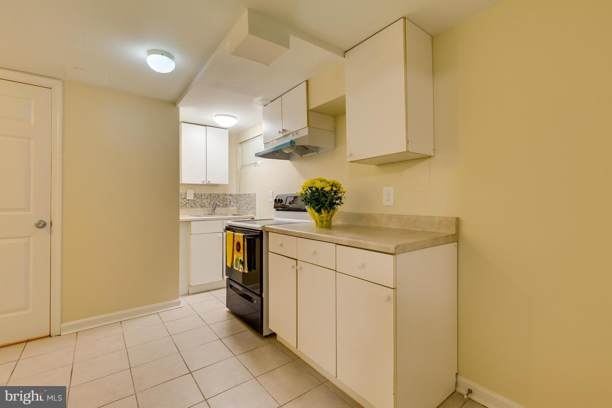 407 Royalton Road Silver Spring, MD 20901 - Photo 20 of 30 a kitchen with a sink cabinets and utility