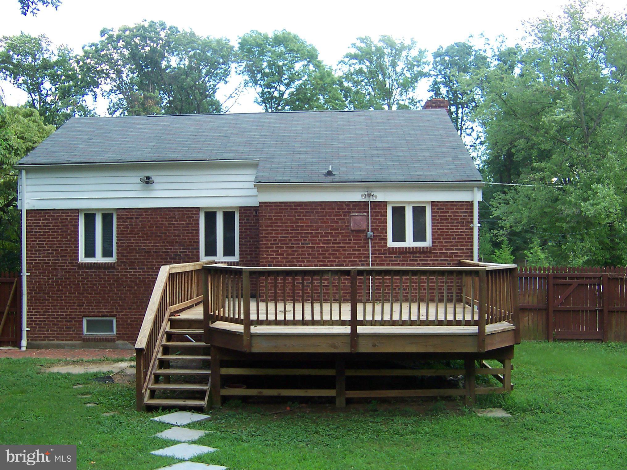 407 Royalton Road Silver Spring, MD 20901 - Photo 24 of 30 a view of a house with a deck and a yard