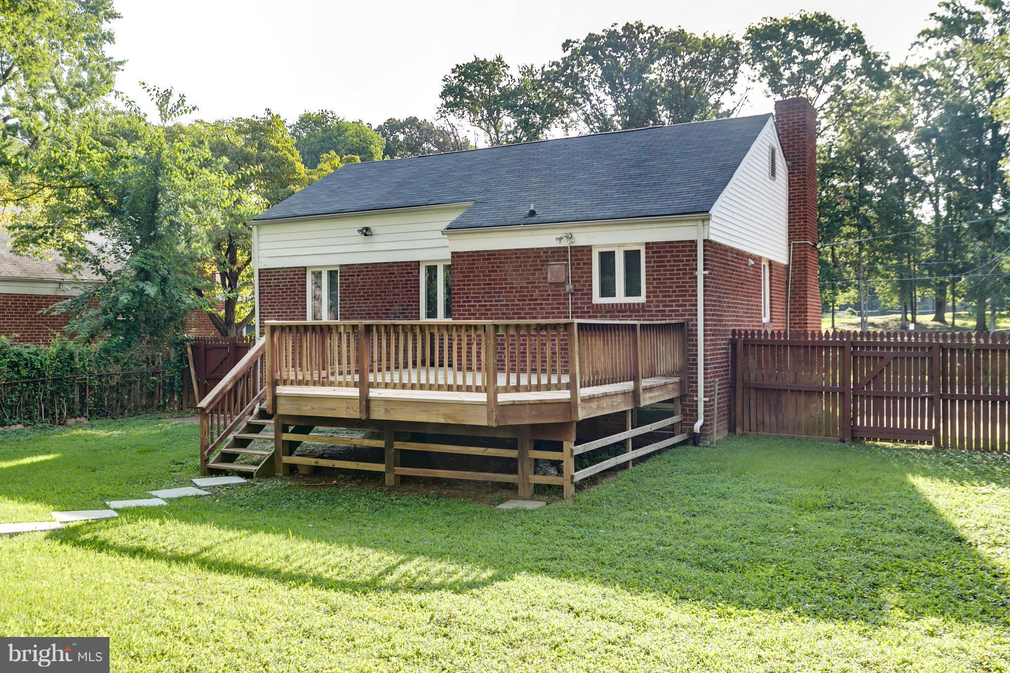 407 Royalton Road Silver Spring, MD 20901 - Photo 26 of 30 a view of a house with a backyard and wooden deck