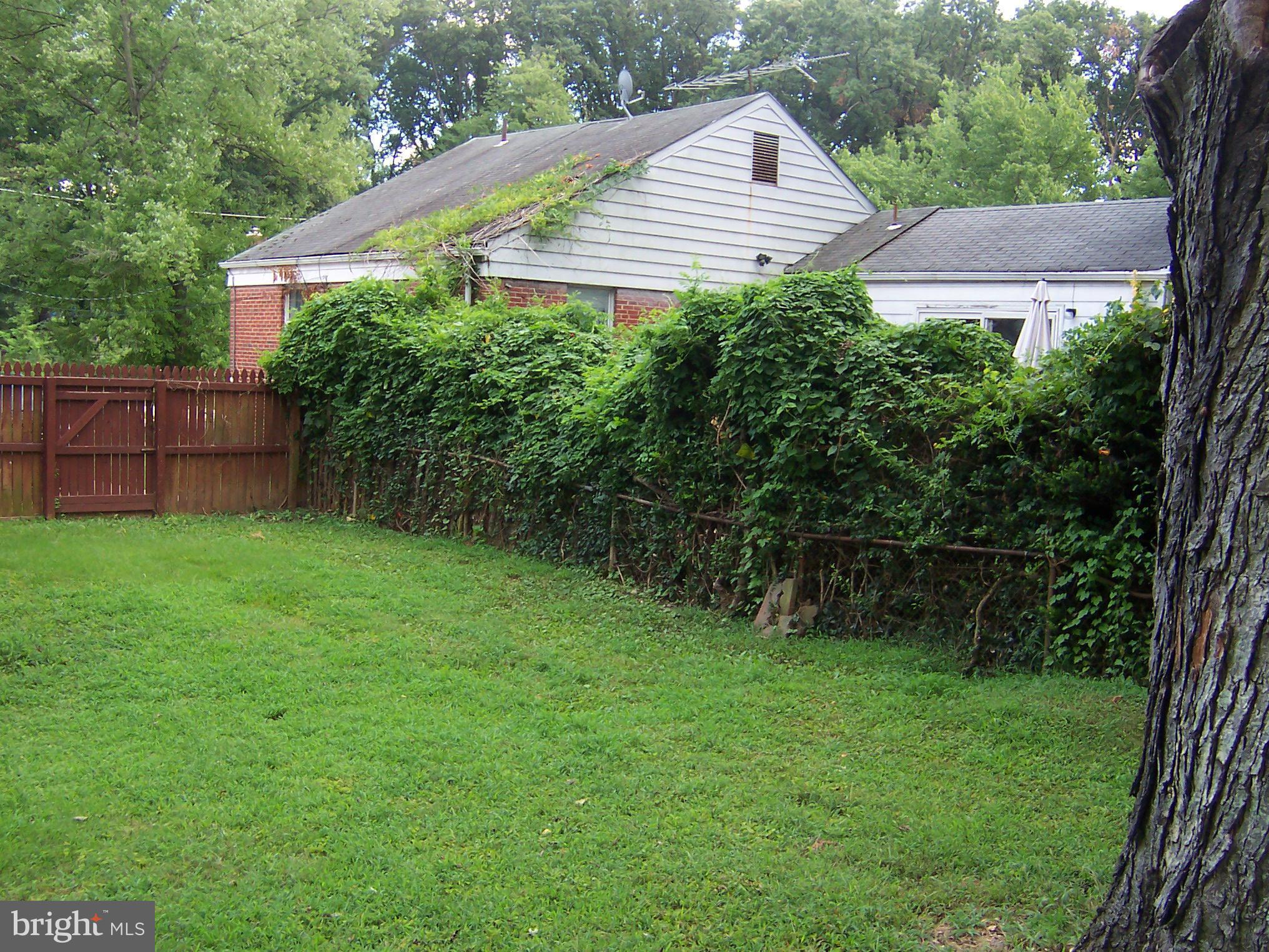 407 Royalton Road Silver Spring, MD 20901 - Photo 30 of 30 a view of a house with a yard and a garden