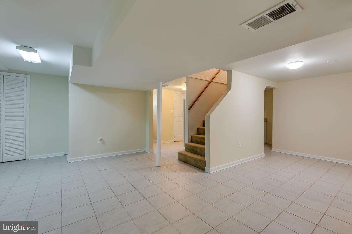 407 Royalton Road Silver Spring, MD 20901 - Photo 4 of 30 an empty room with white walls and white walls