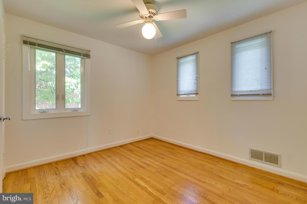 407 Royalton Road Silver Spring, MD 20901 - Photo 7 of 30 a view of empty room with wooden floor and fan