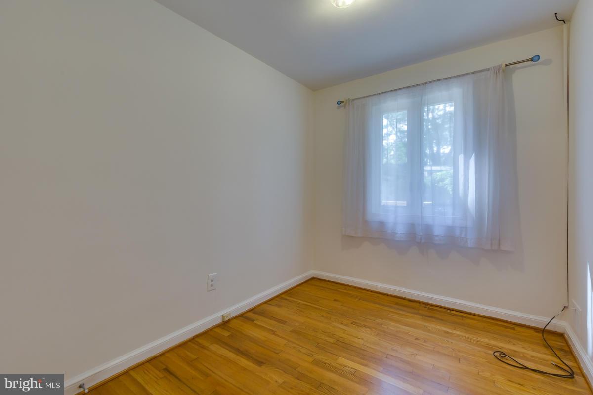 407 Royalton Road Silver Spring, MD 20901 - Photo 10 of 30 a view of empty room with wooden floor and fan