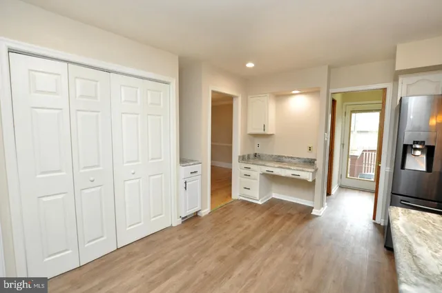 a view of a kitchen with a refrigerator and a sink