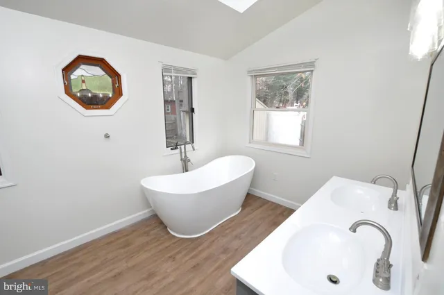 a white bath tub sitting next to a white sink